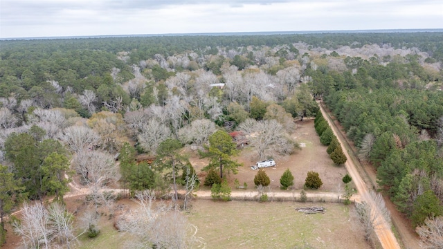 birds eye view of property with a view of trees