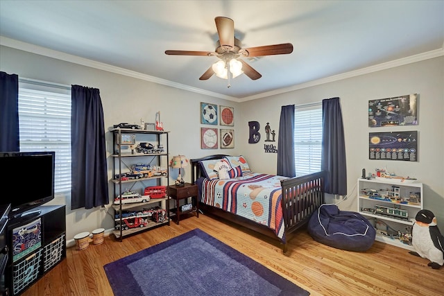 bedroom with crown molding, ceiling fan, and wood finished floors