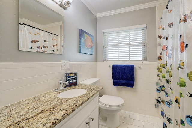 full bath featuring tile patterned flooring, toilet, vanity, wainscoting, and crown molding