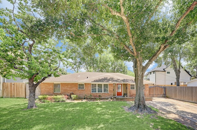 ranch-style home with brick siding, a front lawn, fence, and a gate