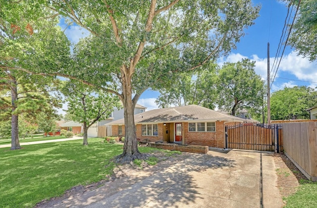 single story home with a front yard, driveway, a gate, and brick siding