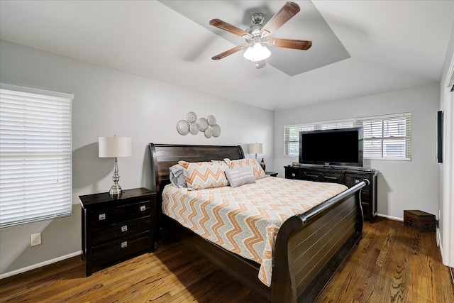 bedroom with lofted ceiling, ceiling fan, baseboards, and wood finished floors