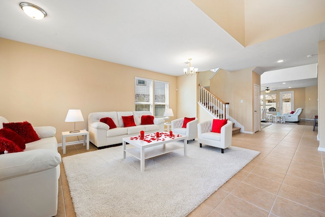 living area with plenty of natural light, stairway, light tile patterned flooring, and baseboards