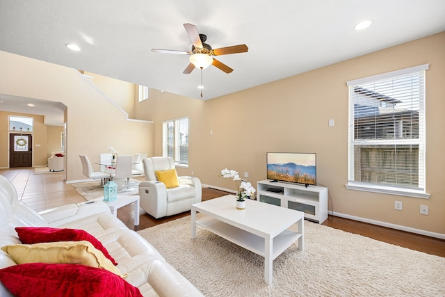 living area with baseboards, a ceiling fan, and recessed lighting