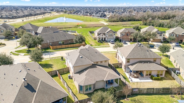 drone / aerial view featuring a water view and a residential view