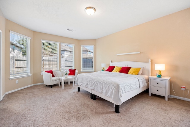 bedroom featuring carpet floors, visible vents, and baseboards