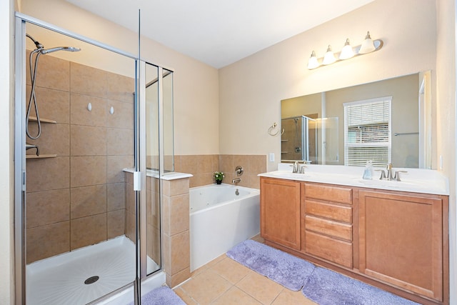 full bathroom featuring a garden tub, tile patterned flooring, a sink, a shower stall, and double vanity