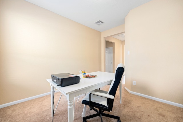 home office featuring light colored carpet, visible vents, and baseboards