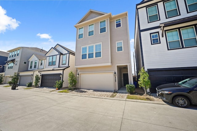 view of property with a garage and a residential view