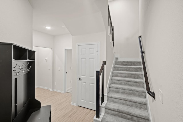 stairs featuring baseboards and wood finished floors