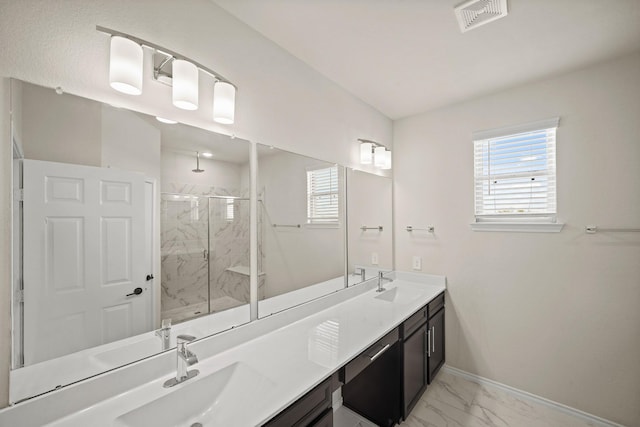 full bath with marble finish floor, plenty of natural light, a sink, and visible vents