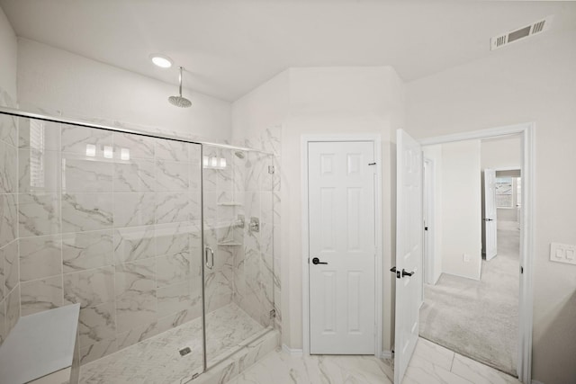 bathroom with marble finish floor, visible vents, and a marble finish shower