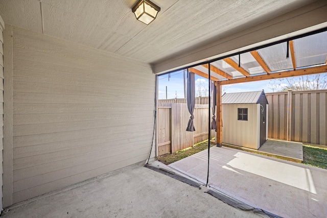 exterior space featuring an outbuilding, a fenced backyard, and a storage unit