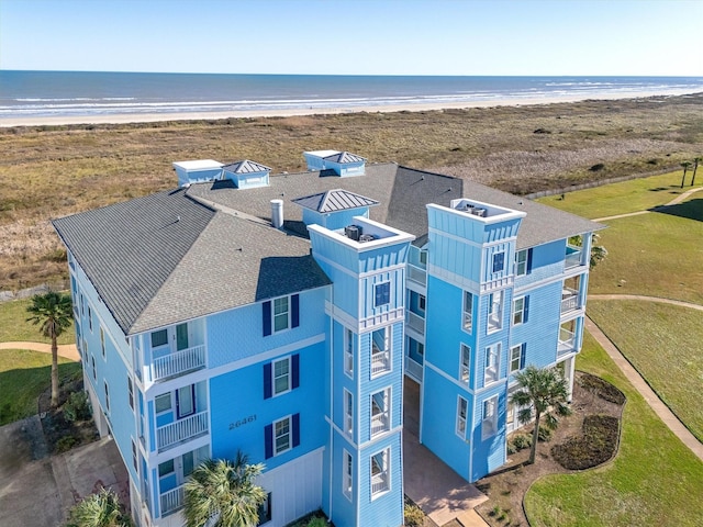 birds eye view of property with a water view and a view of the beach