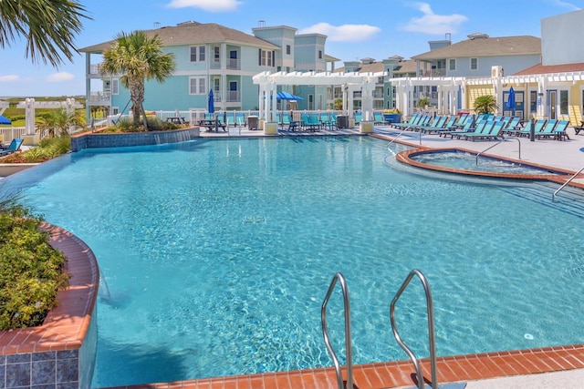 pool with a residential view, fence, a community hot tub, a patio area, and a pergola