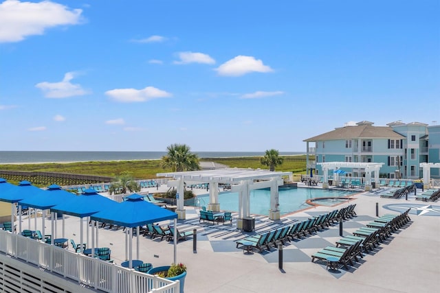 pool featuring a water view, a patio, and a pergola