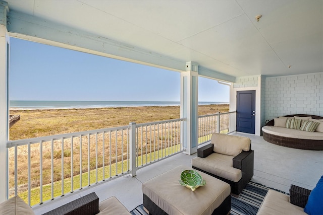 view of patio / terrace featuring an outdoor hangout area, a beach view, and a water view