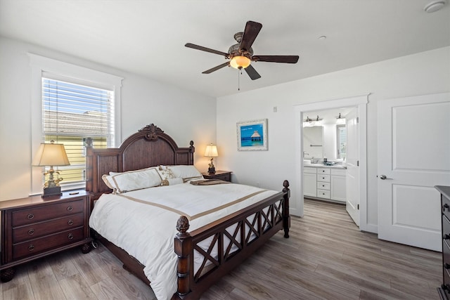 bedroom featuring a ceiling fan, connected bathroom, and wood finished floors