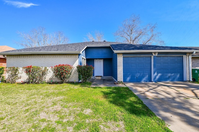 ranch-style home with a front yard, concrete driveway, brick siding, and an attached garage