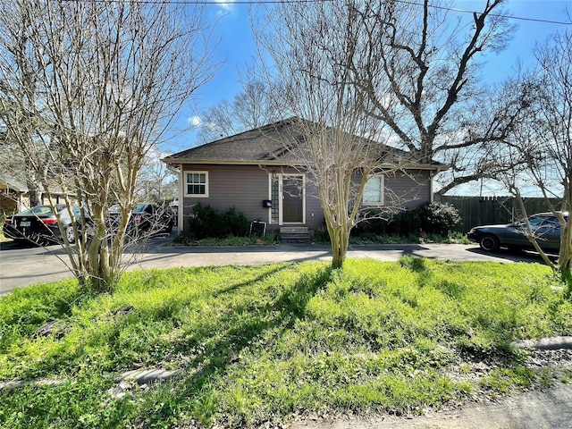 view of front of home featuring driveway, fence, and entry steps