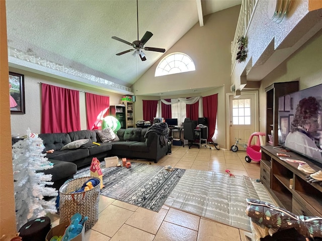 living room featuring ceiling fan, high vaulted ceiling, a textured ceiling, and tile patterned floors