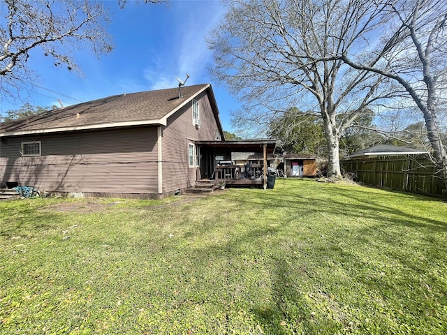 view of property exterior with crawl space, a yard, a wooden deck, and fence