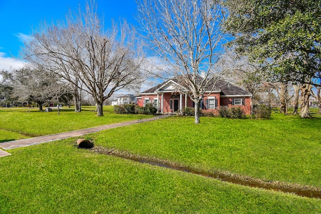 view of front facade featuring a front lawn and brick siding