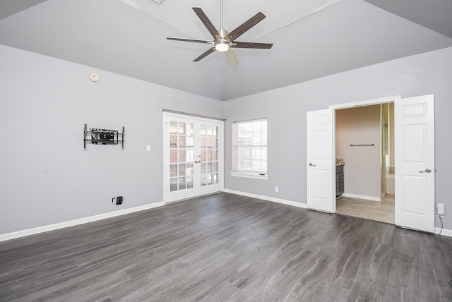 spare room featuring french doors, dark wood-style flooring, ceiling fan, high vaulted ceiling, and baseboards