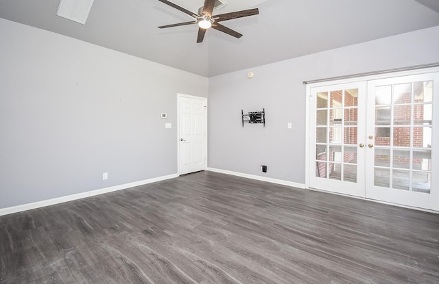 spare room featuring french doors, dark wood finished floors, lofted ceiling, visible vents, and baseboards