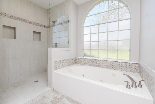 full bathroom featuring a tub with jets and walk in shower