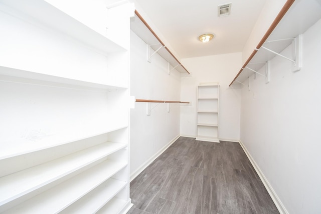 spacious closet with wood finished floors and visible vents