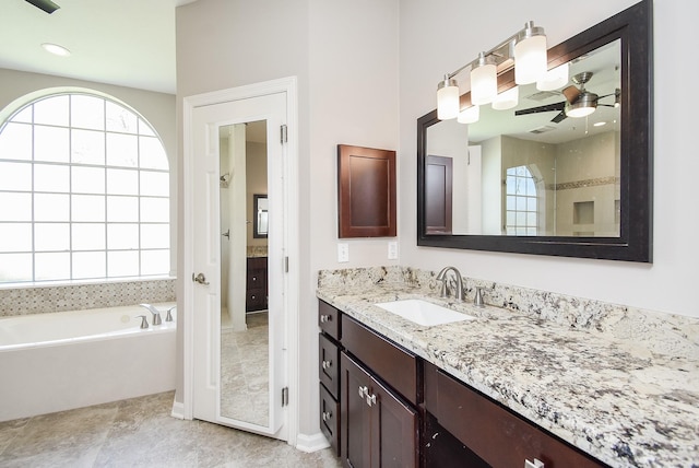 full bathroom with a ceiling fan, visible vents, a garden tub, and vanity