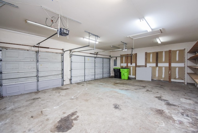 garage with electric panel and a garage door opener