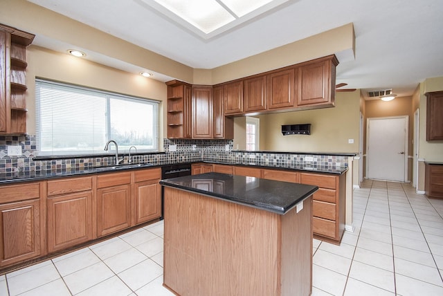 kitchen featuring visible vents, a kitchen island, open shelves, a sink, and light tile patterned flooring