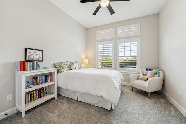 bedroom with a ceiling fan, carpet flooring, and baseboards