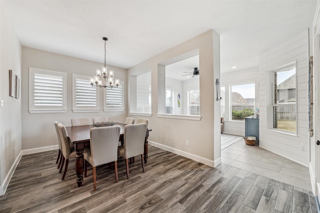 dining space with a notable chandelier, baseboards, and wood finished floors