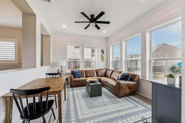 sunroom / solarium featuring ceiling fan