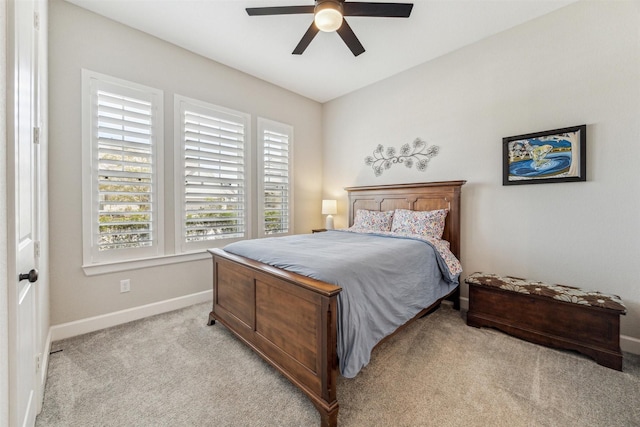 bedroom with baseboards, a ceiling fan, and light colored carpet