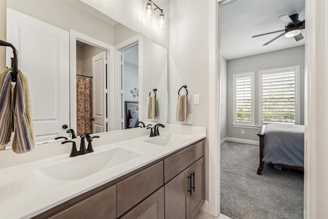 full bath featuring ceiling fan, a sink, baseboards, and double vanity