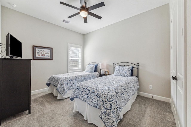 bedroom with carpet floors, a ceiling fan, visible vents, and baseboards