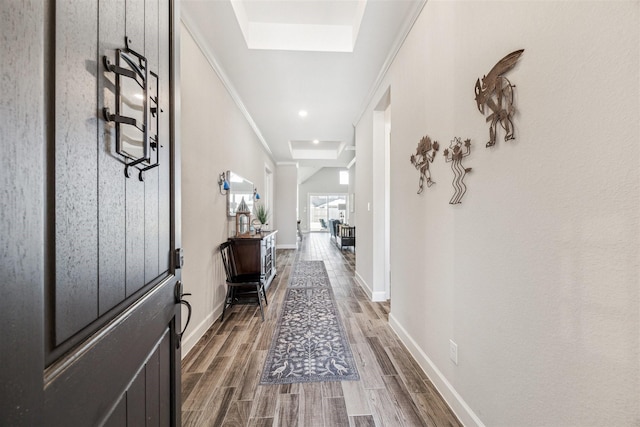 interior space featuring a skylight, baseboards, and dark wood-style flooring