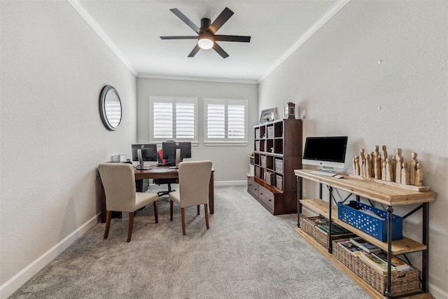 office space with carpet floors, a ceiling fan, baseboards, and crown molding