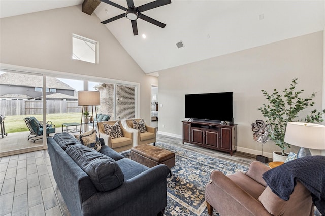 living area featuring high vaulted ceiling, light wood-type flooring, beam ceiling, and baseboards