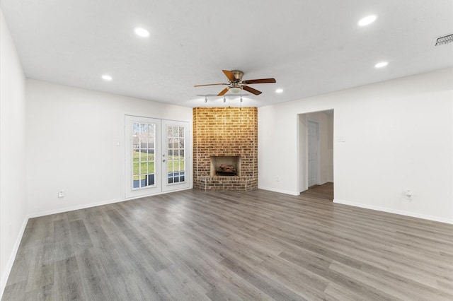 unfurnished living room with recessed lighting, a brick fireplace, ceiling fan, and wood finished floors