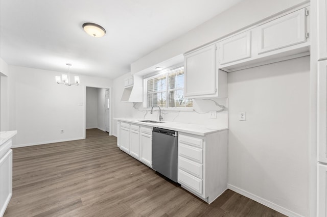 kitchen featuring light countertops, stainless steel dishwasher, light wood-style floors, and white cabinets