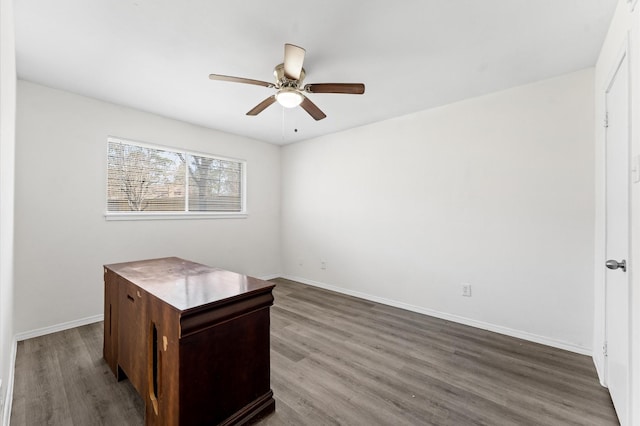 office area featuring ceiling fan, dark wood finished floors, and baseboards