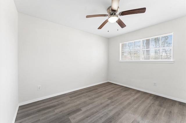 spare room featuring ceiling fan, baseboards, and wood finished floors