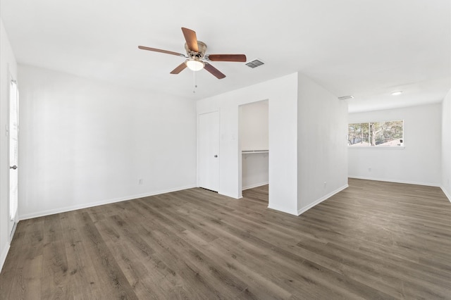 unfurnished bedroom featuring baseboards, visible vents, and wood finished floors