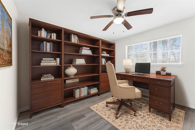 office area featuring ceiling fan, light wood finished floors, and baseboards