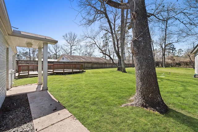 view of yard with fence and a wooden deck